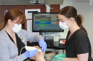 Staff using Trios Scanner on patient